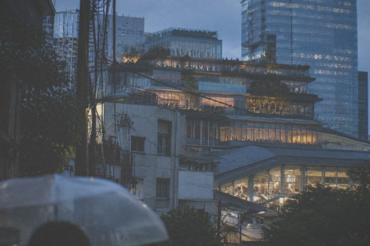 Glass observation deck rooftops above the Shibuya Station area at dusk