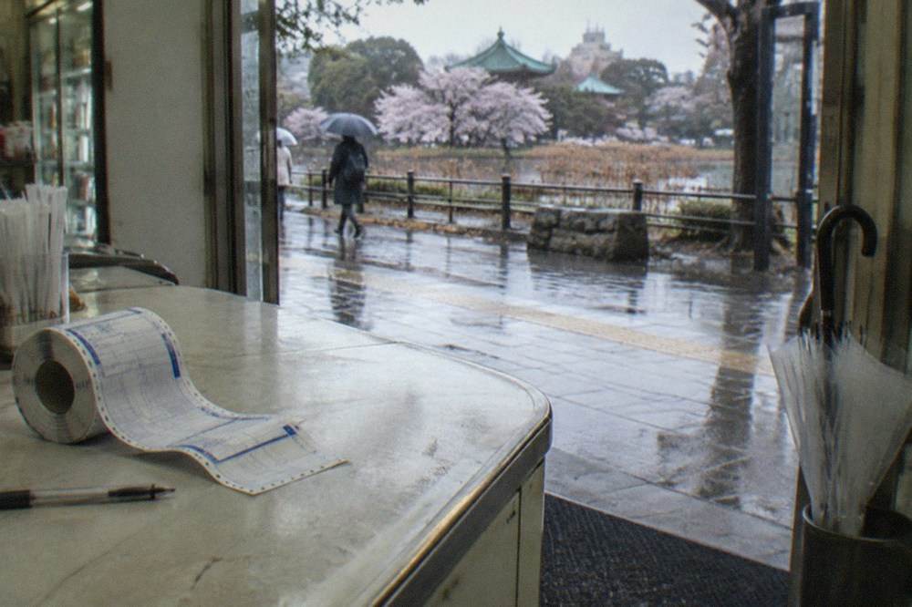 A roll of parcel waybill slips and a pen on a convenience store counter in Tokyo