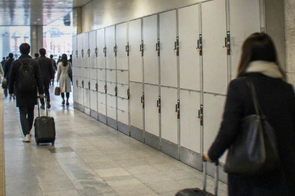 Large and medium coin locker doors with tier labels above them in a JR East station
