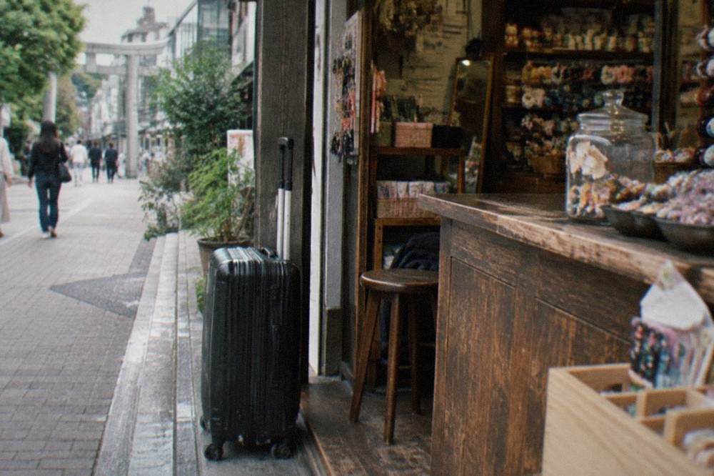 A suitcase parked beside the counter of a small Tokyo shop