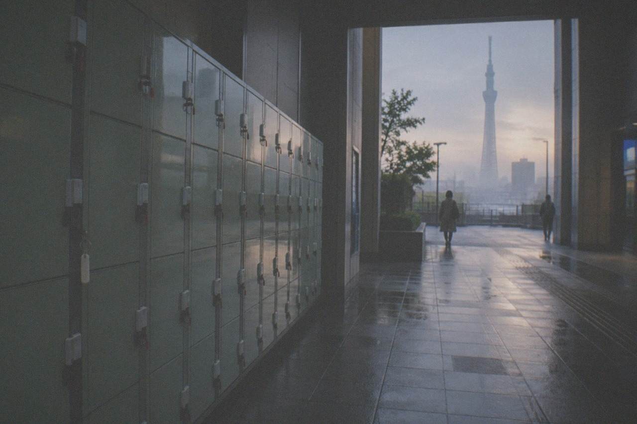 A row of pale green coin lockers along a quiet Tokyo station corridor