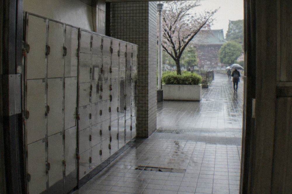 A bank of coin lockers of mixed sizes along a station corridor in Tokyo