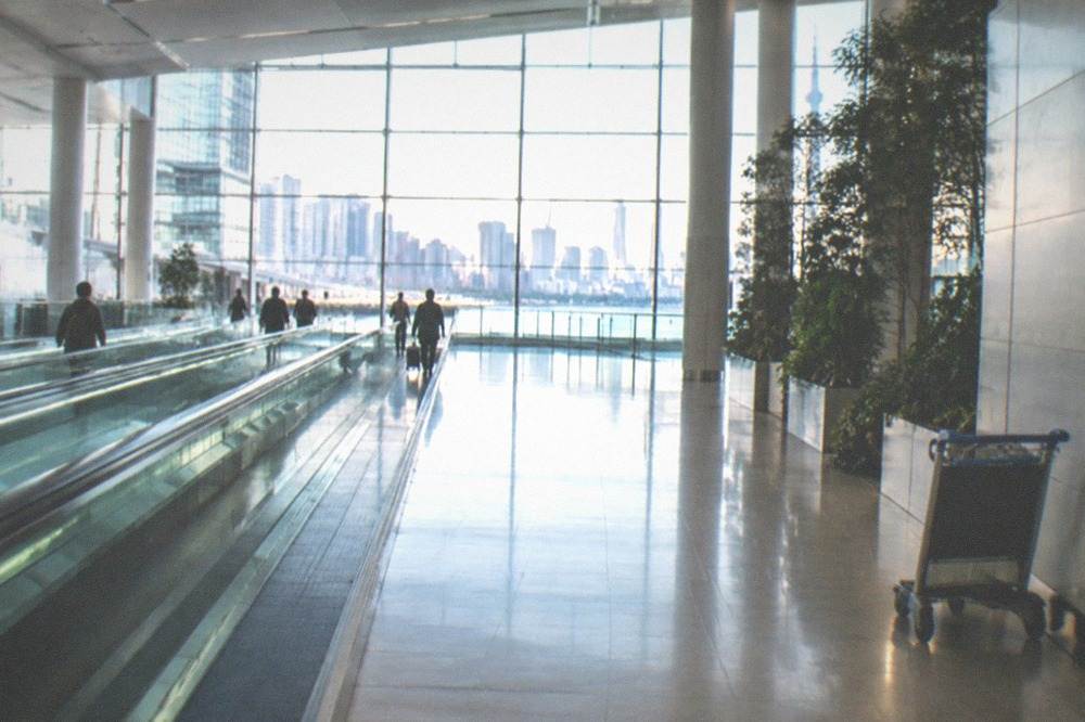Haneda Airport Terminal 3 arrival lobby with travelators and signage