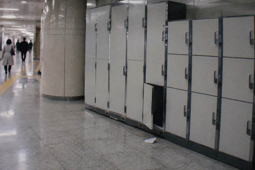 A bank of coin lockers in varying sizes inside a Tokyo subway station