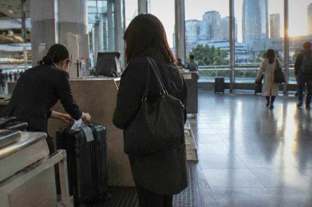 A staffed luggage storage counter inside a Tokyo railway station
