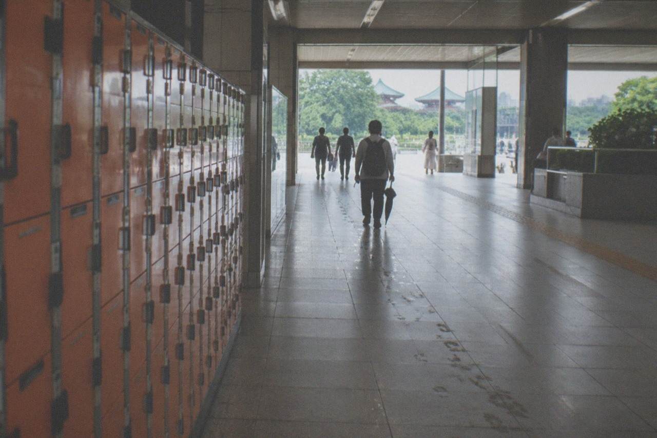 Rows of orange coin lockers along a Tokyo station corridor