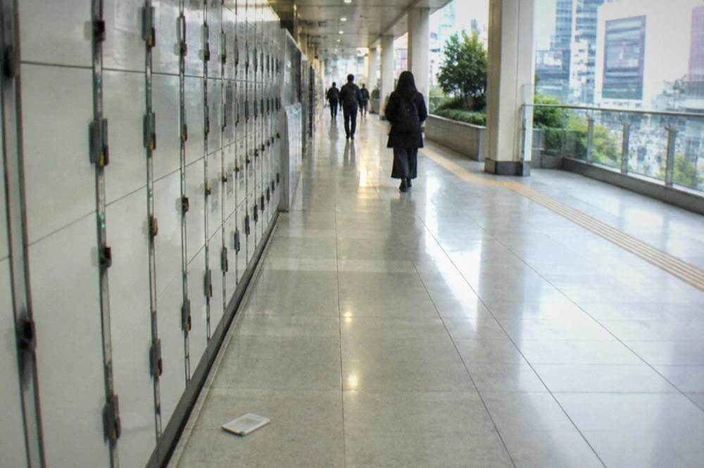 Rows of coin lockers along a bright corridor inside a Tokyo railway station