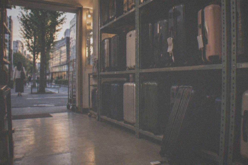 A row of large suitcases waiting in a staffed storage area in Tokyo