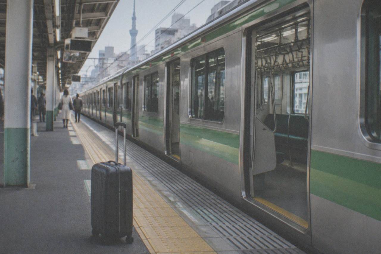 A Tokyo Metro platform with a train arriving beside the yellow tactile paving strip