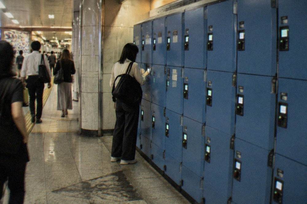A wall of blue coin lockers with electronic screens showing availability