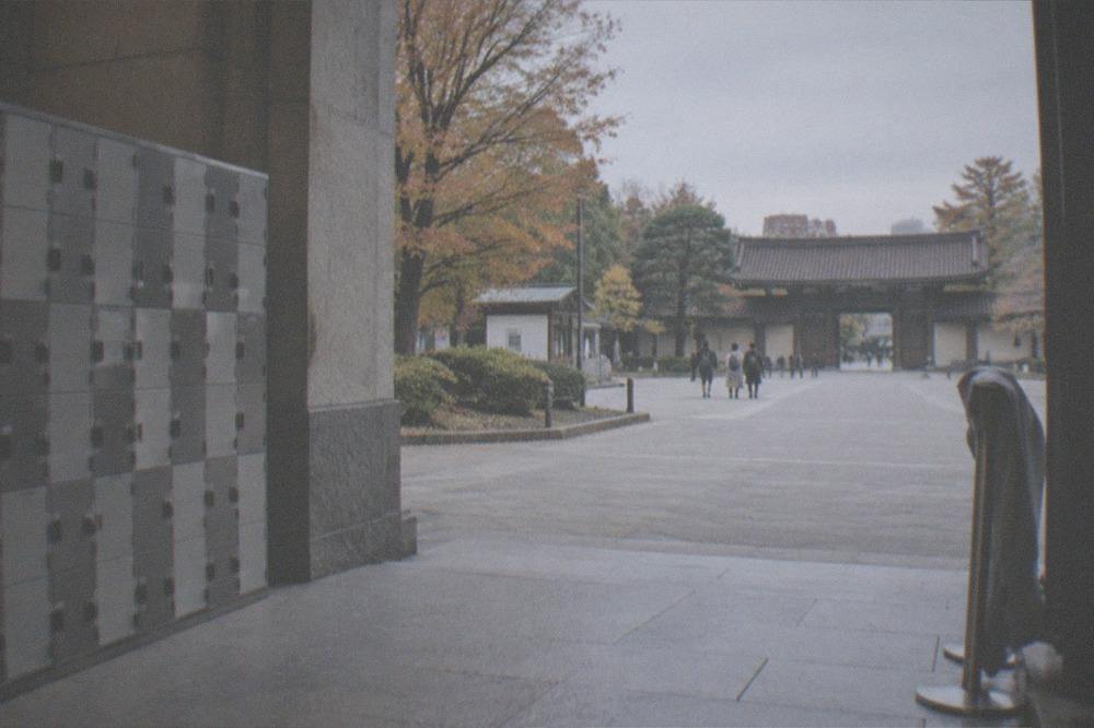 Museum entrance hall with lockers along one wall and an empty walkway, no people.